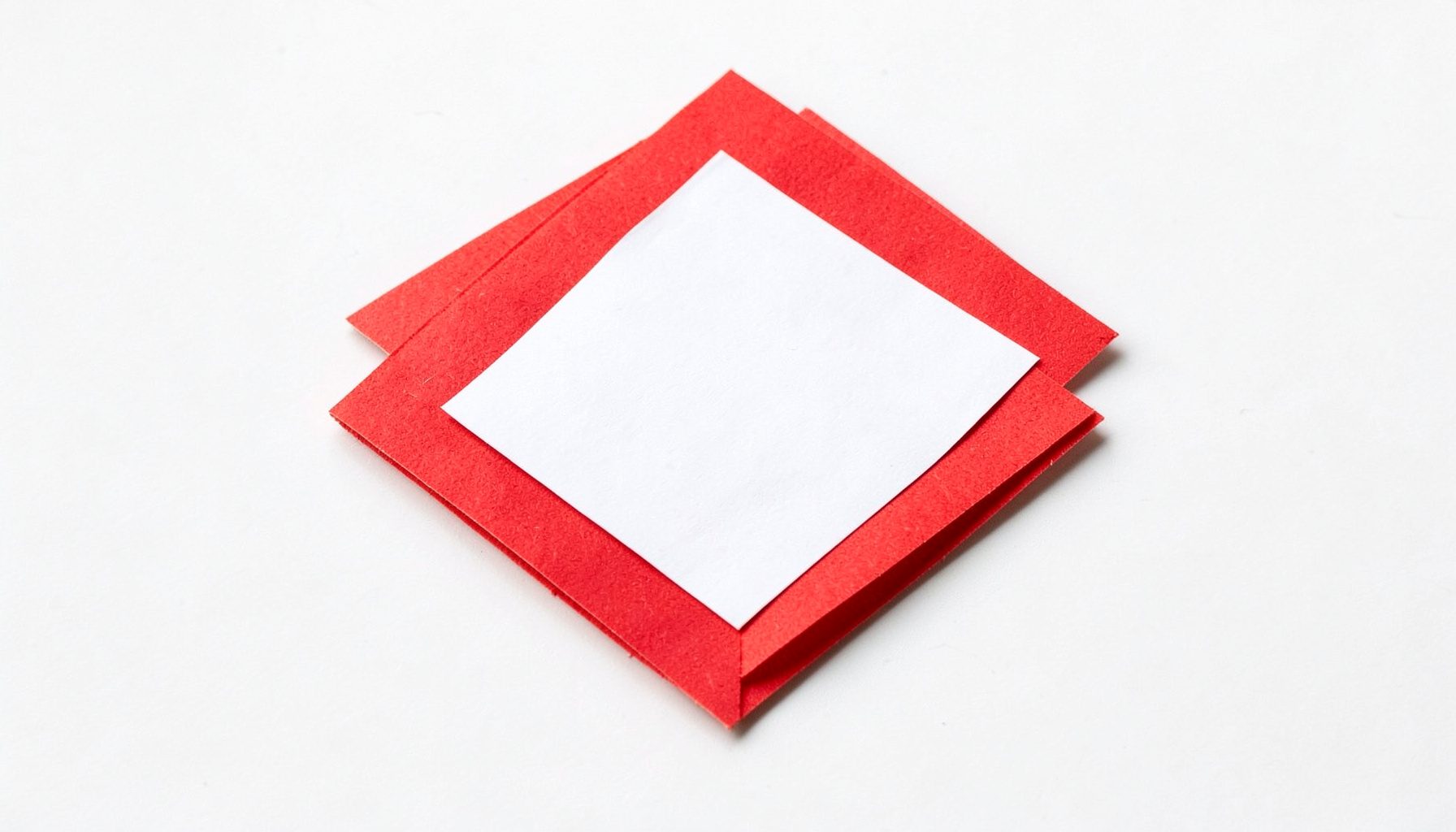 A small layered paper cut-out collage of a ludo board corner in red and white, simple and bright mood