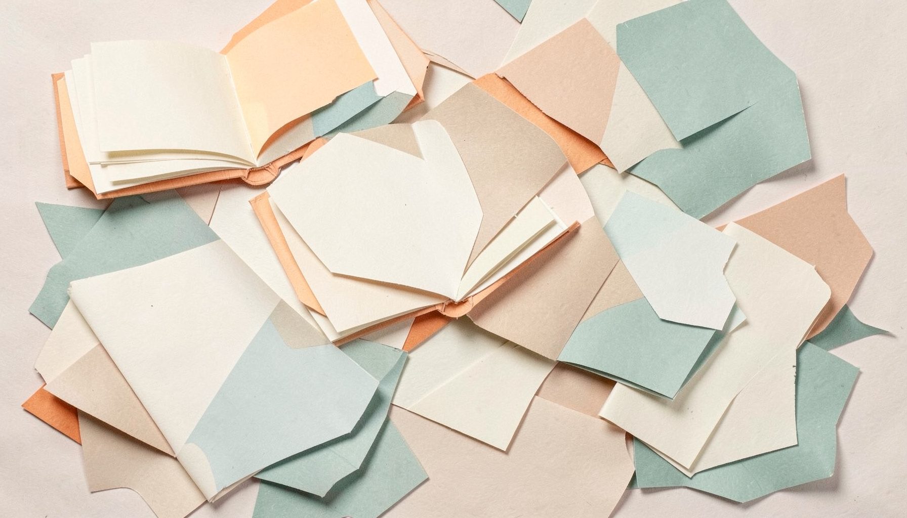 Layered paper cut-out collage of open books and scattered pages in cream, warm beige, and muted teal tones, calm and inviting mood