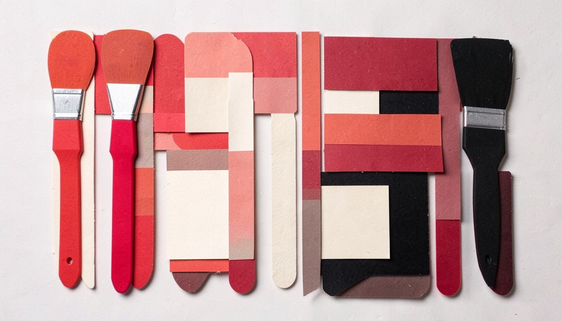 A layered paper cut-out collage of paint brushes and color swatches in red, cream and black arranged neatly, creative mood.