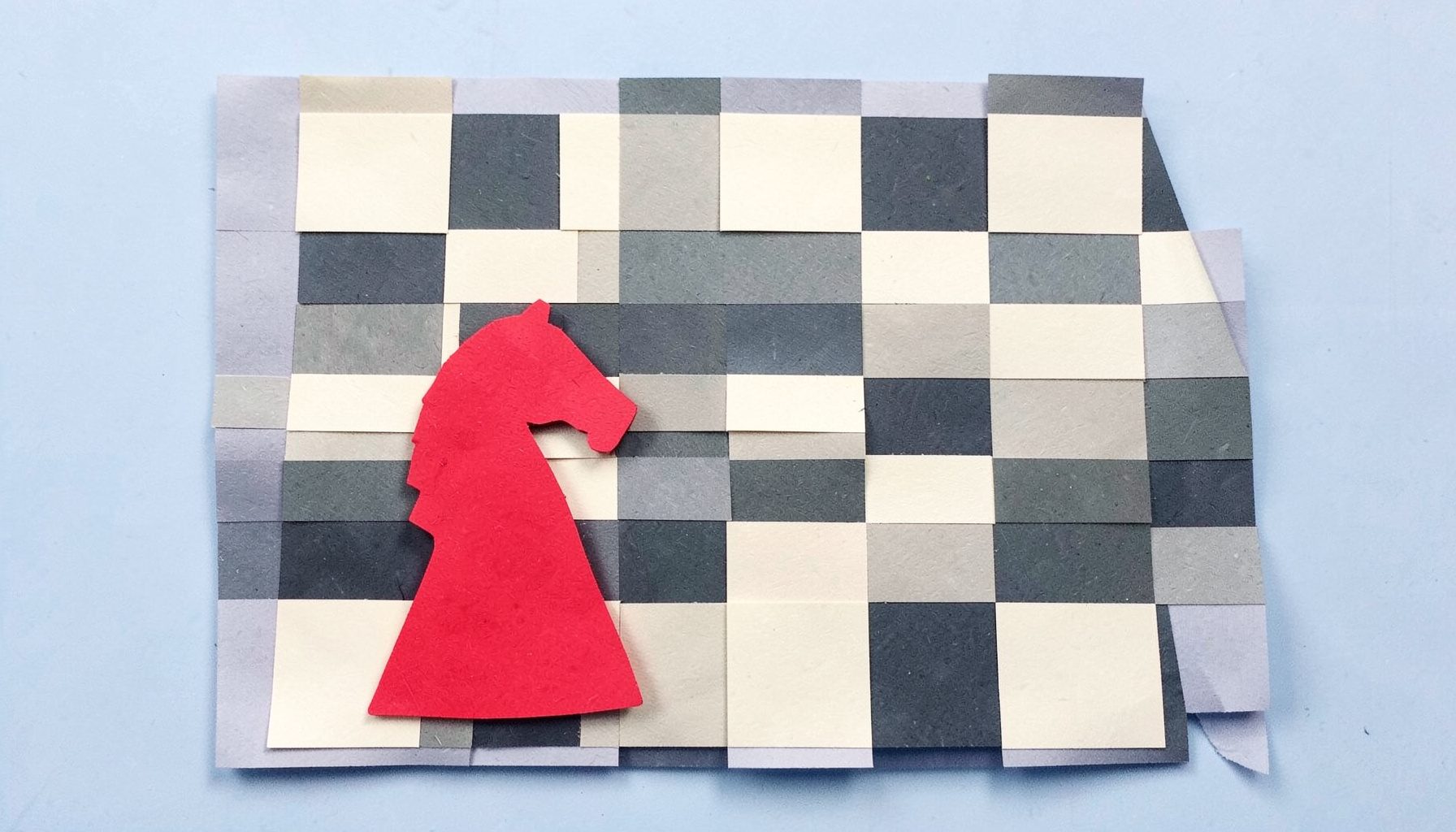 A layered paper cut-out collage of a chessboard with alternating cream and charcoal squares and a red knight piece